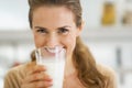 Smiling young woman drinking milk Royalty Free Stock Photo