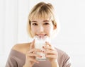 Smiling young woman drinking milk Royalty Free Stock Photo