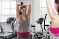 Smiling young woman with dumbbells in the gym. Active lifestyle and health Royalty Free Stock Photo