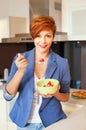 Smiling young woman eating fresh fruits Royalty Free Stock Photo