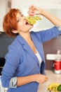 Smiling young woman eating fresh fruits Royalty Free Stock Photo