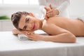 Smiling young woman enjoying healing back massage Royalty Free Stock Photo