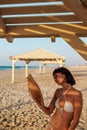 Smiling young woman enjoying her holiday on the beach. Satisfied beautiful girl relaxes on the beach during sunrise Royalty Free Stock Photo