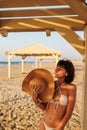 Smiling young woman enjoying her holiday on the beach. Satisfied beautiful girl relaxes on the beach during sunrise Royalty Free Stock Photo