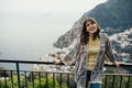 Smiling young woman enoying seaview in Positano,Italy. Vacation on Amalfi coast.Happy tourist in Europe.Italian coast beauty,