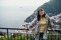 Smiling young woman enoying seaview in Positano,Italy. Vacation on Amalfi coast.Happy tourist in Europe.Italian coast beauty,