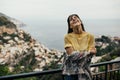 Smiling young woman enoying seaview in Positano,Italy. Vacation on Amalfi coast.Happy tourist in Europe.Italian coast beauty,