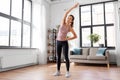 Smiling young woman exercising at home Royalty Free Stock Photo