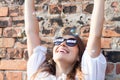 Smiling young woman with freedom sign on sunglasses