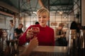 Smiling young woman getting drinks in a bar at night Royalty Free Stock Photo