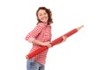 Smiling young woman with giant red pencil Royalty Free Stock Photo