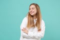 Smiling young woman girl in casual white hoodie posing isolated on blue turquoise wall background studio portrait Royalty Free Stock Photo