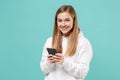 Smiling young woman girl in casual white hoodie posing isolated on blue turquoise wall background studio portrait Royalty Free Stock Photo