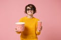 Smiling young woman girl in 3d imax glasses posing isolated on pink background. People in cinema, lifestyle concept