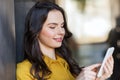 Smiling young woman or girl texting on smartphone Royalty Free Stock Photo