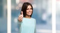 Smiling young woman giving thumbs up Royalty Free Stock Photo