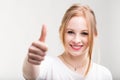 Smiling young woman giving a thumbs up Royalty Free Stock Photo