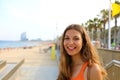 Smiling young woman going to Barceloneta, famous Barcelona beach, Catalonia, Spain. Royalty Free Stock Photo