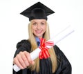 Smiling young woman in graduation gown showing diploma Royalty Free Stock Photo