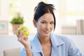 Smiling young woman with green apple Royalty Free Stock Photo