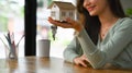 Smiling young woman hand holding house model and keys. New house, insurance and real estate concept Royalty Free Stock Photo