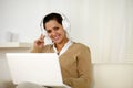 Smiling young woman with headphone looking at you Royalty Free Stock Photo