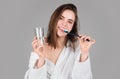 Smiling young woman with healthy teeth holding a tooth brush. Human teeth. Dental health care clinic. Close-up of a Royalty Free Stock Photo