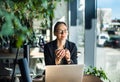 Smiling young woman at her desk in office working on computer with a cup of coffee Royalty Free Stock Photo