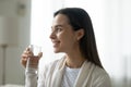 Smiling young woman hold glass with clean mineral water Royalty Free Stock Photo