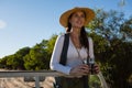 Young woman holding binoculars looking away while standing in off road vehicle Royalty Free Stock Photo