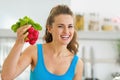 Smiling young woman holding bunch of radishes Royalty Free Stock Photo