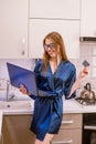 Smiling young woman holding credit card and blue laptop computer in hands Royalty Free Stock Photo