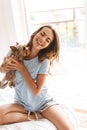 Smiling young woman holding dog Royalty Free Stock Photo