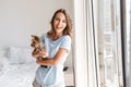 Smiling young woman holding dog Royalty Free Stock Photo