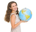 Smiling young woman holding globe Royalty Free Stock Photo