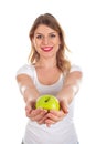 Smiling young woman holding a green apple Royalty Free Stock Photo