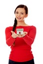 Smiling young woman holding house model Royalty Free Stock Photo