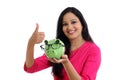 Smiling young woman holding piggy bank Royalty Free Stock Photo