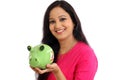 Smiling young woman holding piggy bank - Savings concept Royalty Free Stock Photo