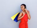 Smiling young woman holding shopping bags talking on cell phone Royalty Free Stock Photo