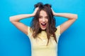 Smiling young woman holding to her head or hair Royalty Free Stock Photo