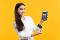 Smiling young woman holding wireless modern bank payment terminal to process and acquire credit card payments Royalty Free Stock Photo