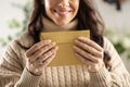 A smiling young woman holds a mail envelope made of recycled paper in her hands Royalty Free Stock Photo