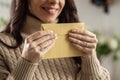 A smiling young woman holds a mail envelope made of recycled paper in her hands Royalty Free Stock Photo