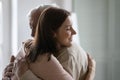 Smiling young woman hugging older man, enjoying tender moment Royalty Free Stock Photo