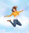 Smiling young woman jumping high in air Royalty Free Stock Photo