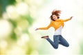 Smiling young woman jumping high in air Royalty Free Stock Photo