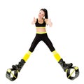 Smiling young woman in kangoo jumps shoes showing fingers up Royalty Free Stock Photo