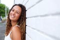 Smiling young woman leaning against a wall Royalty Free Stock Photo