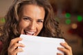 Smiling young woman licking envelope